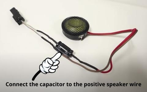 connect the capacitor to the positive speaker wire